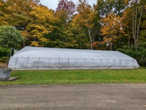 This hoop house is located next to my Stable Barn and across the carriage road from my vegetable gardens. It is currently one of three hoop houses on the farm, but not for long. We're constructing a new one nearby. I will share photos when it is all done.