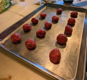 Next, Elvira forms 12 meatballs - she was able to make 14 - and places them all equally spaced on a lightly oiled baking sheet.
