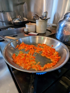 After heating two teaspoons of oil in a medium skillet over medium-high heat, Elvira starts to cook the peppers, stirring them until tender and lightly browned - just about five minutes.