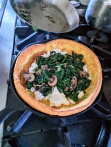 ... and then tops it with the mushrooms and spinach mixture.