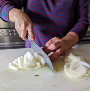 She also finely chops the onion.