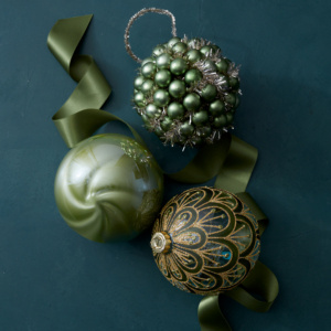 Thinking of something more bold for your holiday tree? Try out these Draped Glitter Ball Ornaments. The art deco flair and glittering green hues offer a fresh and stylish look to any tree.