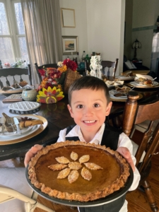 Helen's nephew Giovanni is holding and giving thanks for the butternut squash pie I made for Helen the day before. Every year, I make pies for everyone on my farm team to thank them for all the hard work they do all year long.