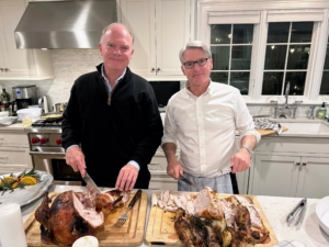 Meanwhile, in the kitchen, dueling turkeys, dueling carving - the two turkey carvers, John and David Morris, are hard at work. One turkey was smoked, and the other was roasted.
