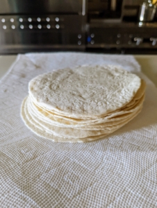 The tortillas are unwrapped and softened in the microwave for about 30 to 40 seconds.