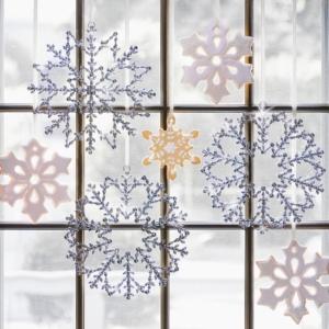 For sparkle on your window, use my 12-inch Round Petaled Snowflakes mixed with iced sugar cookies. The petaled snowflakes are available on Martha.com in two colors - silver and gold.