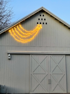 And here above my Equipment Barn doors is my Martha Stewart LED 30-inch Shooting Star available at Martha.com. I love these shooting stars and hang one on every building at my farm during the holidays. I hope you're enjoying this week before Christmas. And Happy Hanukkah to all those who celebrate!