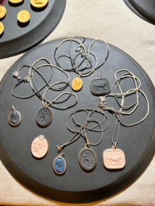 Marcie also makes jewelry. These are cameo pendant necklaces - some are set in silver and gold.
