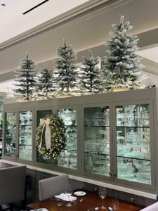 More wreaths and flocked trees decorate the tops of these cabinets. Don't forget to consider higher surfaces to add your décor.