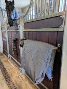 These turnout blankets are very lightweight and are easy to fold and keep in front of each horse's stall.