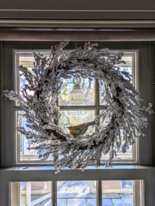 Indoors, on each of the windows in my servery we hung silver wreaths. The servery is between my sitting room and my kitchen. A servery is a room from which meals are served. Whenever I entertain, I like to use the area for serving desserts and drinks.