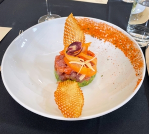 This is tuna and salmon tartare - with avocado, shaved vegetable salad, and gaufrettes - small crispy, potato wafers cut like waffles.