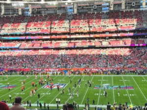 Seats filled up quickly. The players were able to warm up on the field before the game. The Eagles are in midnight green and the Chiefs are in white with red.