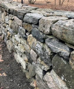 Here is one section all done. It is quite impressive to see how the stones fit together so perfectly for a very level, straight wall.