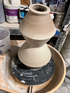 Here is the lamp on the potters wheel where more hand work is done to remove the lines from the slip cast molding process.