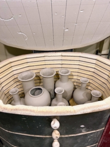 Christopher's team fills the kilns in the afternoon and then lets the lamps sit overnight in 1900 degrees Fahrenheit. At this stage, they can pack them in pretty tightly. Once the glaze is put on and fired again in the kiln, the lamps will not be allowed to touch each other.