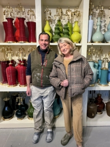 I always enjoy visiting the studios where beautiful handmade items are manufactured. Here I am with Christopher at his Manhattan studio where he "creates jewelry for the home." We're standing in front of a wall of shelves filled with some of his gorgeous and colorful lamps - ready for their new homes.