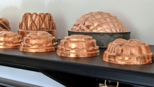 Many of my molds are on display on this shelf. Jello, or jelly, molds became popular during the Victorian era when cooks experimented with recipes such as meat-based aspic. Copper molds, as opposed to the more affordable tin alternatives, were a sign of wealth. And by the 1950s and 1960s, these pieces were used for other recipes, especially those well-loved jelly creations.