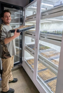 Ryan places the trays in our Urban Cultivator growing system – it has water, temperature and humidity all set-up in this refrigerator like unit. And then it’s back to seeding more trays – there are a lots and lots of seeds to plant. Seeds are usually started about two months before the last frost – we will be planting seeds well into March. Learn more about seed starting on "Martha Gardens" streaming free on The Roku Channel.