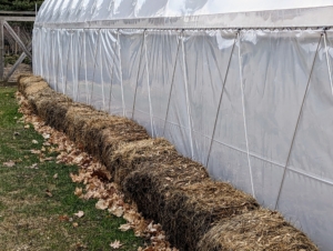 Outside, more bales of hay are used to give the structures more insulation.