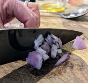While the pepper continue cooking, Stephanie finely chops the shallot that's included with the kit. It's so convenient to have all the ingredients included, so there is no need to shop.