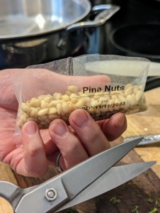 Pine nuts are also very nutritious. They're about a 1/2 inch long. When raw, the seeds have a soft texture and a sweet, buttery flavor. They are also called piñón, pinoli, pignoli, bondoq or chilgoza. This recipe calls for one-ounce of pine nuts.