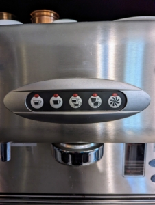 This is one of the machine's two push button panels. It has five key buttons. The star like symbol on the far right is the continuous and programming button. The other four are volumetric keys which set the amount or strength of the beverage being made.
