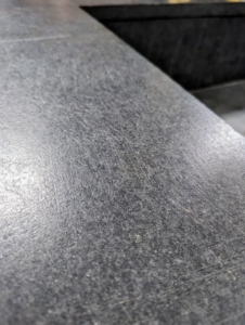The countertops are in great condition in part because of the maintenance we do. Periodic application of mineral oil will help it develop a dark patina and enhance the natural aging process of the soapstone.
