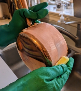 Completely coat the piece with cream. The copper will start to brighten as it is rubbed. This task is time-consuming, but it is well-worth all the work and elbow grease. And remember to get into the cracks and crevices.