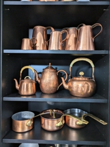 The copper looks so pretty gleaming on the shelves and hanging from the hooks. Another tip: if you like the way your displays are arranged, take a quick snapshot before you remove them, so you know exactly how they should be returned.