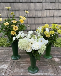 And green enamel flower holders from the tag sale with flowers from their garden.