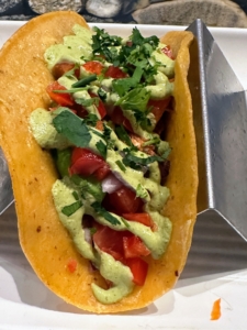 This taco was served on an organic corn tortilla filled with sautéed wild-caught cod, topped with bell pepper, tomato, onion, avocado, cilantro, and cashew-lime cilantro sauce.