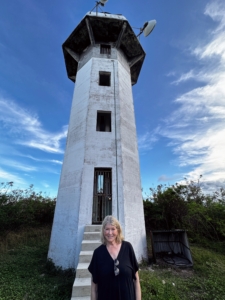 Here I am in front of a defunct lighthouse. While many lighthouses still stand and serve as visual aids, modern electronic navigation now plays a larger role in maritime safety.