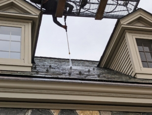 After waiting about 30-minutes, Pete rinses the solution with a power washer. This is also a good time to inspect the roof closely for any broken or misaligned tiles - everything is in good condition.