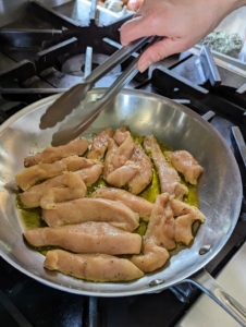 We sliced the chicken breasts into strips before cooking, but one can also cut them after the chicken is cooked.