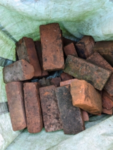 I have thousands of these bricks. "Pressed red" is the general term given to solid red bricks traditionally manufactured from clay, pressed into individual molds by hand, and then heated at very high temperatures.