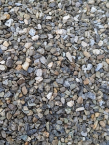 Next, is the gravel. All around the farm, I like to use quarter-inch native washed stone. Each stone is about the size of a pea. This same gravel stone is also used to line the paths in my flower cutting garden. It s nice to keep everything uniform when possible.