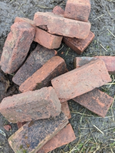 I have thousands of these red clay bricks. “Pressed red” is the general term given to solid red bricks traditionally manufactured from clay, pressed into individual molds by hand, and then heated at very high temperatures. Each of these antique and vintage bricks measures about eight and-a-half inches by four inches.