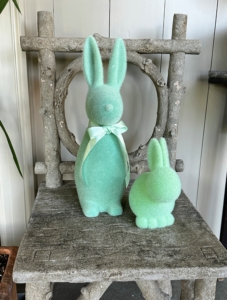 And inside, every room is filled with charming Easter themed figures, more springtime blooms, and eggs in all sizes and colors. These two bright green bunnies are watching all the holiday activities from a faux bois seat in my indoor porch.