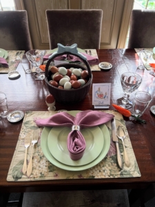 The table was also decorated with seasonal plants and flowers, a variety of colorful eggs, and Easter bunnies. The place settings are always so beautiful and different from year to year. This year, I selected muted tones of green and tan with these cheerful dark pink-lavender napkins folded like rabbit ears. Do you remember these place mats? They're from my original Collection at Kmart.