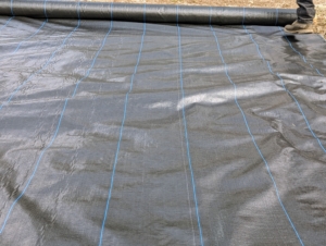 And then he unrolled the weed fabric on top, covering the entire space.