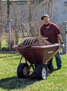 Here's my outdoor grounds crew foreman, Chhiring, bringing over wheelbarrows filled with my nutrient-rich compost made right here at the farm.