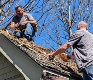 Here is a closer look at the shingles being removed. The four man crew works quickly. This day was unusually warm - about 85-degrees Fahrenheit.