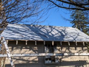 Next, the team cleans the area and covers the roof with a synthetic roofing underlayment – a layer of protection installed between the roof deck and the new roofing panels. It provides ventilation as well as a backup waterproof membrane in case of leakage.