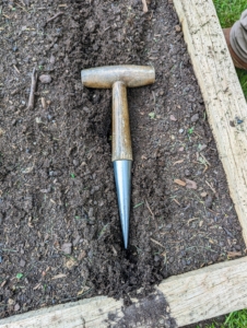 A dibber or dibble or dibbler is a pointed wooden stick for making holes in the ground so that seeds, seedlings or small bulbs can be planted. Dibbers come in a variety of shapes including the straight dibber, the T-handled dibber like this one, the trowel dibber, and the L-shaped dibber.