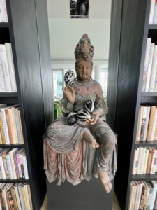 Here is the other Guanyin bodhisattva - this one is holding up an egg with three others resting on her lap.