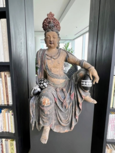 This is one of two Guanyin bodhisattvas. Guanyin is the Chinese translation of Avalokiteshvara, the bodhisattva of compassion, mercy, and love. For Easter, both figures are adorned with decorated eggs.