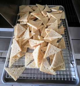 Triangular melba toasts prepared for the Ossetra caviar.