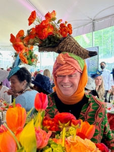 There are always all kinds of hats at the luncheon. This is author and television host, Christopher Mason, in his cornucopia of flowers hat.