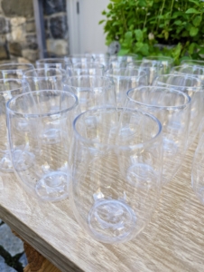 Sustainable, reusable, shatterproof wine glasses by Govino are displayed in tidy rows for our cocktails.